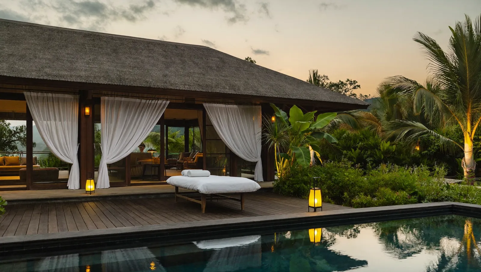 Massage table set up on a Bali villa terrace at sunset overlooking the pool
