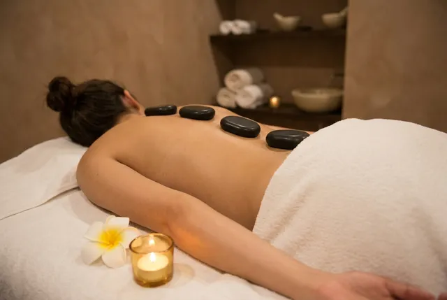 Hot stone massage with warm volcanic stones on the back in Bali